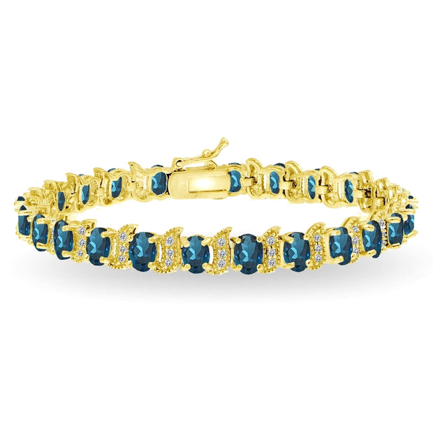 Yellow Gold Flashed Sterling Silver London Blue Topaz 6x4mm Oval and S Tennis Bracelet with White Topaz Accents