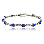 Sterling Silver Created Blue Sapphire 6x4mm Oval Infinity Bracelet with White Topaz Accents