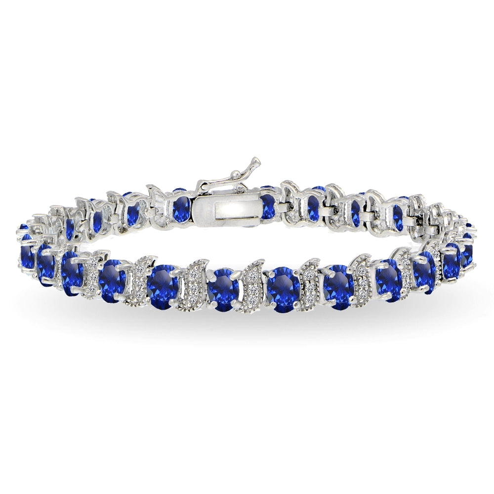 Sterling Silver Created Blue Sapphire 6x4mm Oval and S Tennis Bracelet with White Topaz Accents