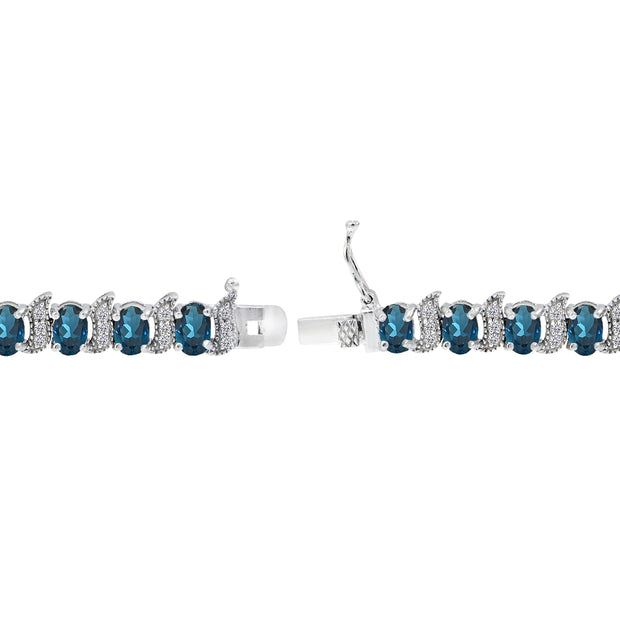 Sterling Silver London Blue Topaz 6x4mm Oval and S Tennis Bracelet with White Topaz Accents