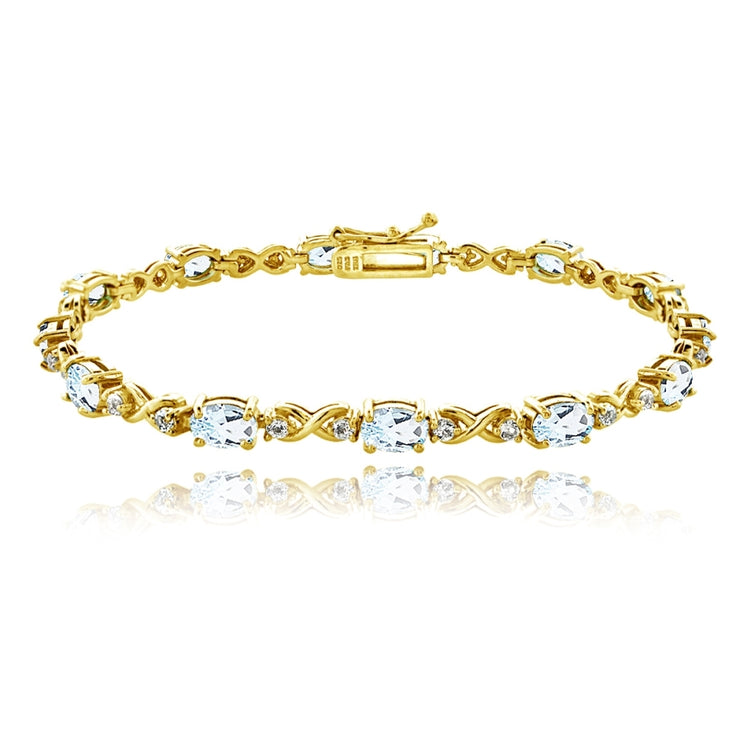 Yellow Gold Flashed Sterling Silver Blue Topaz 6x4mm Oval Infinity Bracelet with White Topaz Accents