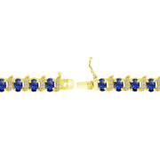 Yellow Gold Flashed Sterling Silver Created Blue Sapphire 6x4mm Oval and S Tennis Bracelet with White Topaz Accents