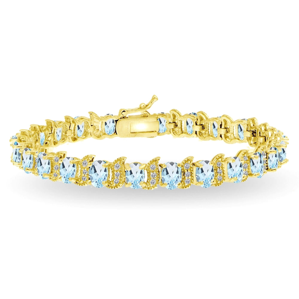 Yellow Gold Flashed Sterling Silver Blue Topaz 6x4mm Oval and S Tennis Bracelet with White Topaz Accents